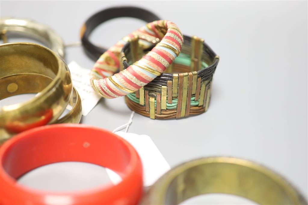 A collection of bangles, including five ethnic white metal examples,